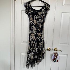 Flirty sequence dress black with hues of gold and off white satin.